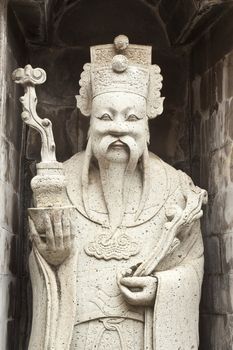 one of the eight statues of gods, according to chinese beliefs, found in a chinese temple.