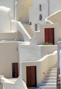 Close up on white architecutre with stairs, window and doors at Oia, Santorini, Greece, by sunny day.