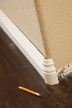 New Baseboard and Bull Nose Corners with Laminate Flooring Abstract.