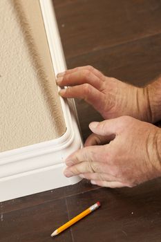 Contractor Installing New Baseboard with Bull Nose Corners and New Laminate Flooring Renovation Abstract.