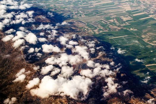 view of the mountains from an airplane above the clouds