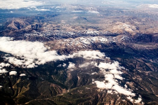 view of the mountains from an airplane above the clouds