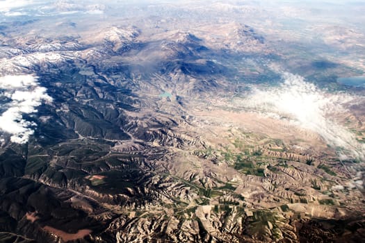 view of the mountains from an airplane above the clouds