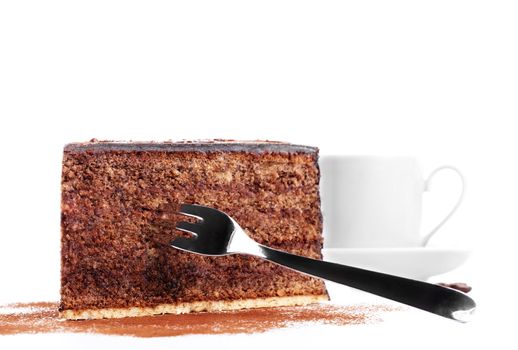 chocolate cake with a fork and a cup of coffee in background on white background