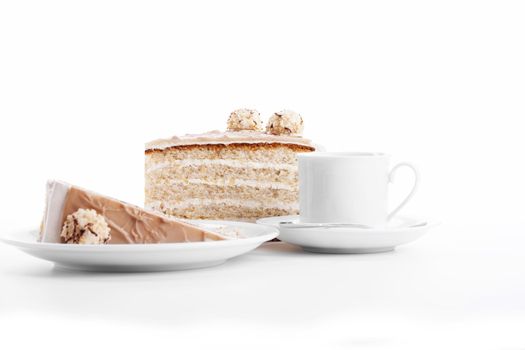 hazelnut cream cake with a cup of coffee on white background