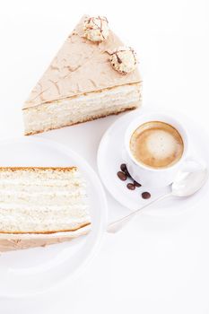 hazelnut cream cake from top with a cup of coffee on white background