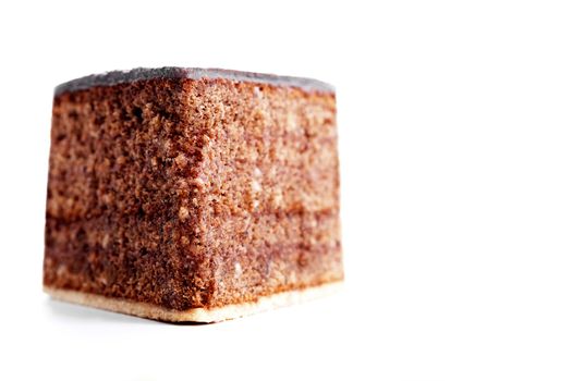 piece of a chocolate cake from front on white background