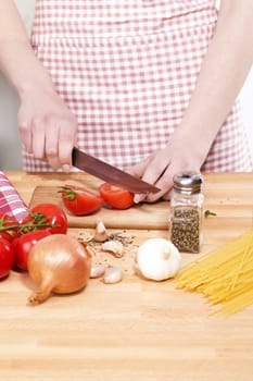 closeup of hands cutting vegetables for pasta