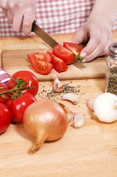 closeup of hands preparing vegetables for italian food