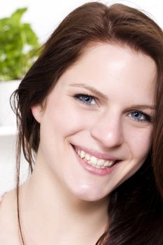 portrait of a happy young woman in a kitchen