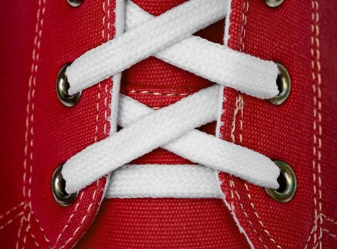 White lace on red sneakers close up