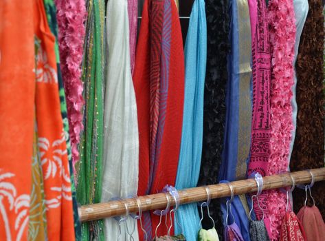Colorful fabric on a rack at an outdoor shop