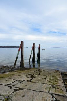 Three pylons along a boat ramp. Located along the maine coast.