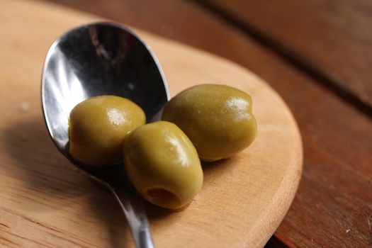 filled olives on a spoon