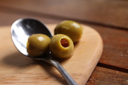 filled olives on a spoon