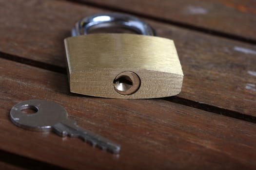 padlock with key on wooden background