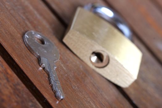 padlock with key on wooden background