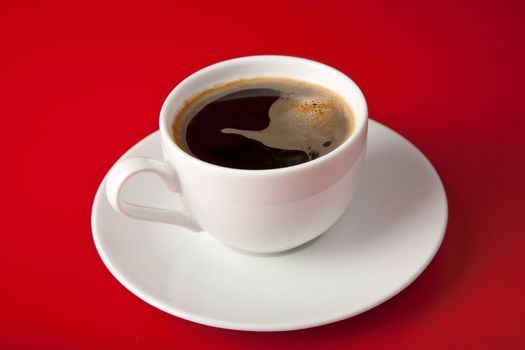 cup of coffee over red background
