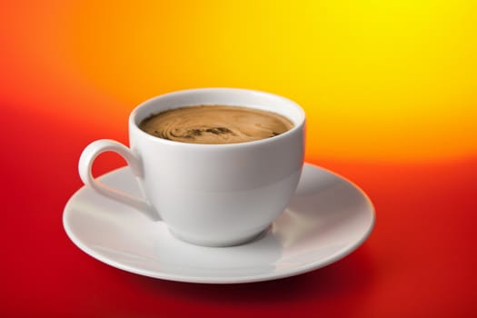 cup of coffee over red and yellow background