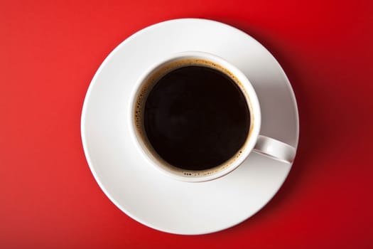 cup of coffee over red background