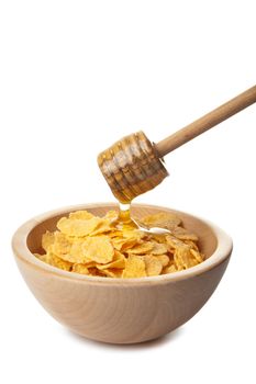 honey pouring over cornflakes isolated