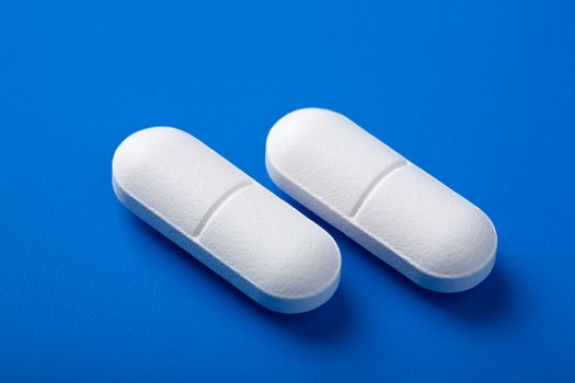 white pills over blue
