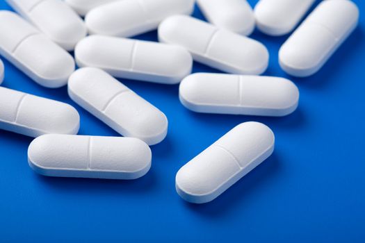 white pills over blue

