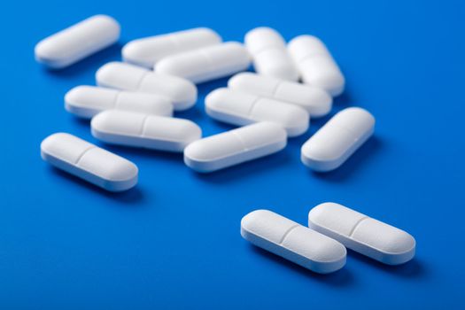 white pills over blue 