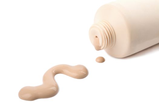liquid foundation spilled out of bottle isolated
