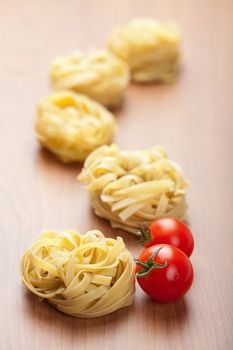 raw pasta tagliatelle and tomatoes