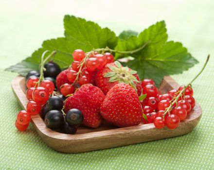 fresh berries in wooden bowl 