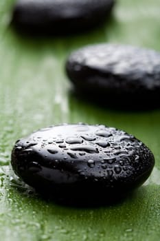 black spa stones over leaf