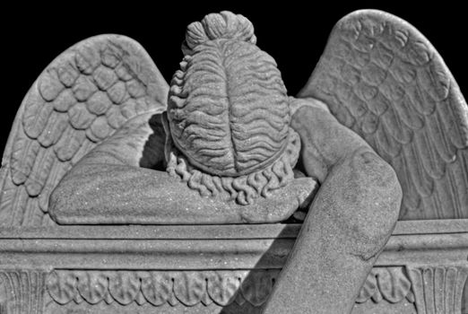 Black and white view of crying angel monument
