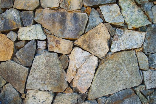 Texture of rock wall in shade for background purposes
