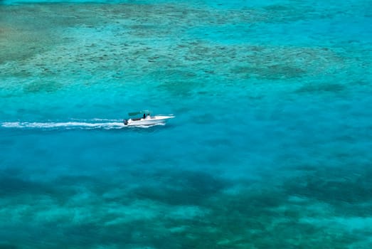 Turquoise caribbean waters and small power boat