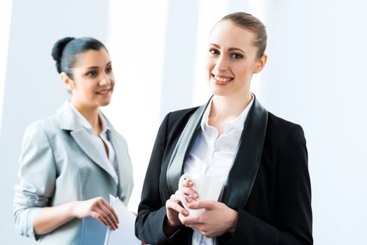 two business women discussing documents in the office