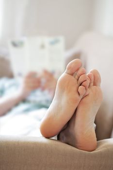 man relaxing on sofa. focus on feet