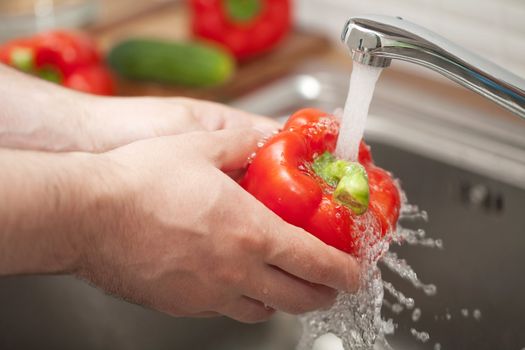 man washing vegetable