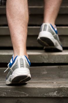 legs of running man on stairs