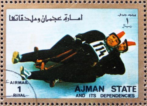 AJMAN - CIRCA 1973: a stamp printed in the Ajman shows Two-man Sledge, Winter Olympics, circa 1973