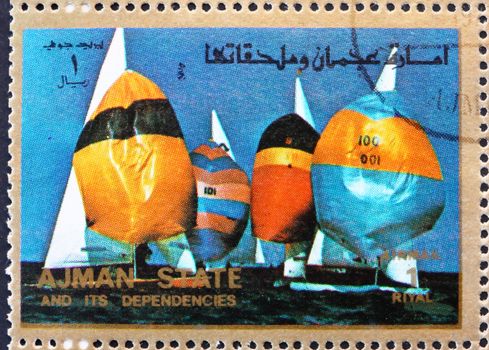 AJMAN - CIRCA 1973: a stamp printed in the Ajman shows Sailing, Summer Olympics, circa 1973