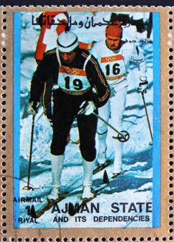 AJMAN - CIRCA 1973: a stamp printed in the Ajman shows Cross-country Skiing, Winter Olympics, circa 1973