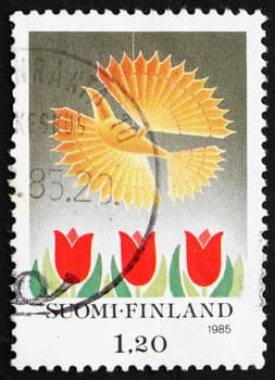 FINLAND - CIRCA 1985: a stamp printed in the Finland shows Bird and Tulips, Christmas, circa 1985