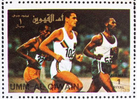 UMM AL-QUWAIN - CIRCA 1972: a stamp printed in the Umm al-Quwain shows Sprint, Running, Athletics, Summer Olympics, Munich 1972, circa 1972