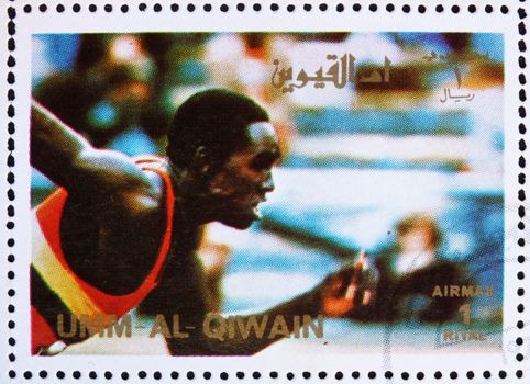 UMM AL-QUWAIN - CIRCA 1972: a stamp printed in the Umm al-Quwain shows Sprint, Running, Athletics, Summer Olympics, Munich 1972, circa 1972