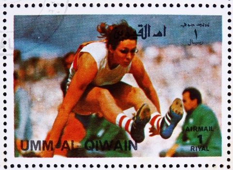 UMM AL-QUWAIN - CIRCA 1972: a stamp printed in the Umm al-Quwain shows Long Jump, Athletics, Summer Olympics, Munich 1972, circa 1972