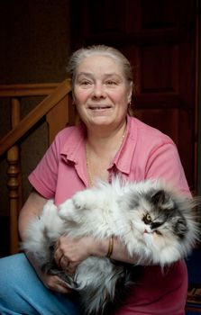 Pensioner with his beloved cat in her arms