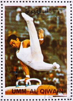 UMM AL-QUWAIN - CIRCA 1972: a stamp printed in the Umm al-Quwain shows Pommel Horse, Gymnastics, Summer Olympics, Munich 1972, circa 1972