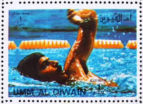 UMM AL-QUWAIN - CIRCA 1972: a stamp printed in the Umm al-Quwain shows Mark Spitz, USA, Winner of the Summer Olympics Munich 1972, circa 1972