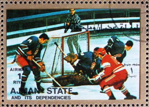AJMAN - CIRCA 1973: a stamp printed in the Ajman shows Ice Hockey, Winter Olympics, circa 1973